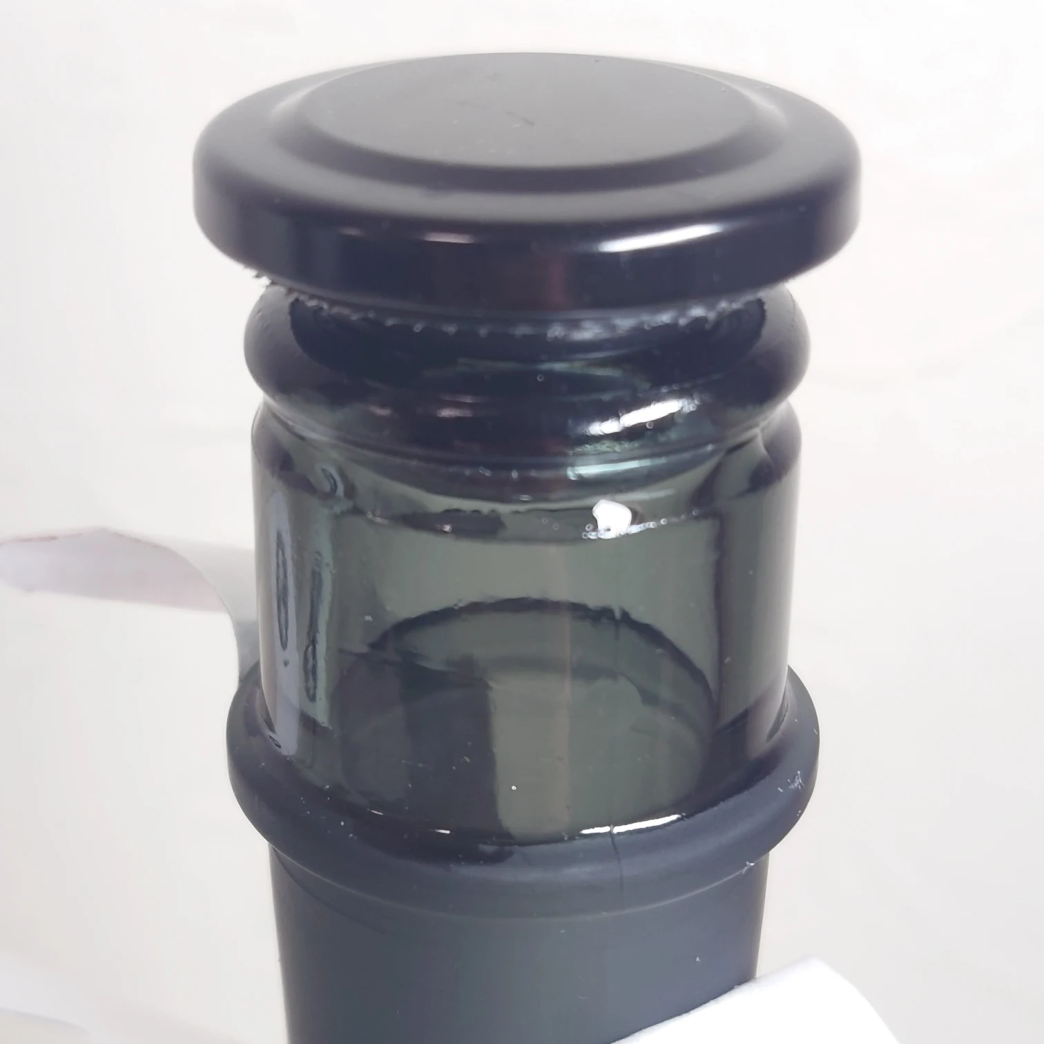 日本酒「野良 Nora」本金—一升瓶用の黒い瓶栓を採用、四合瓶でも開けやすい工夫が感じられるクローズアップ