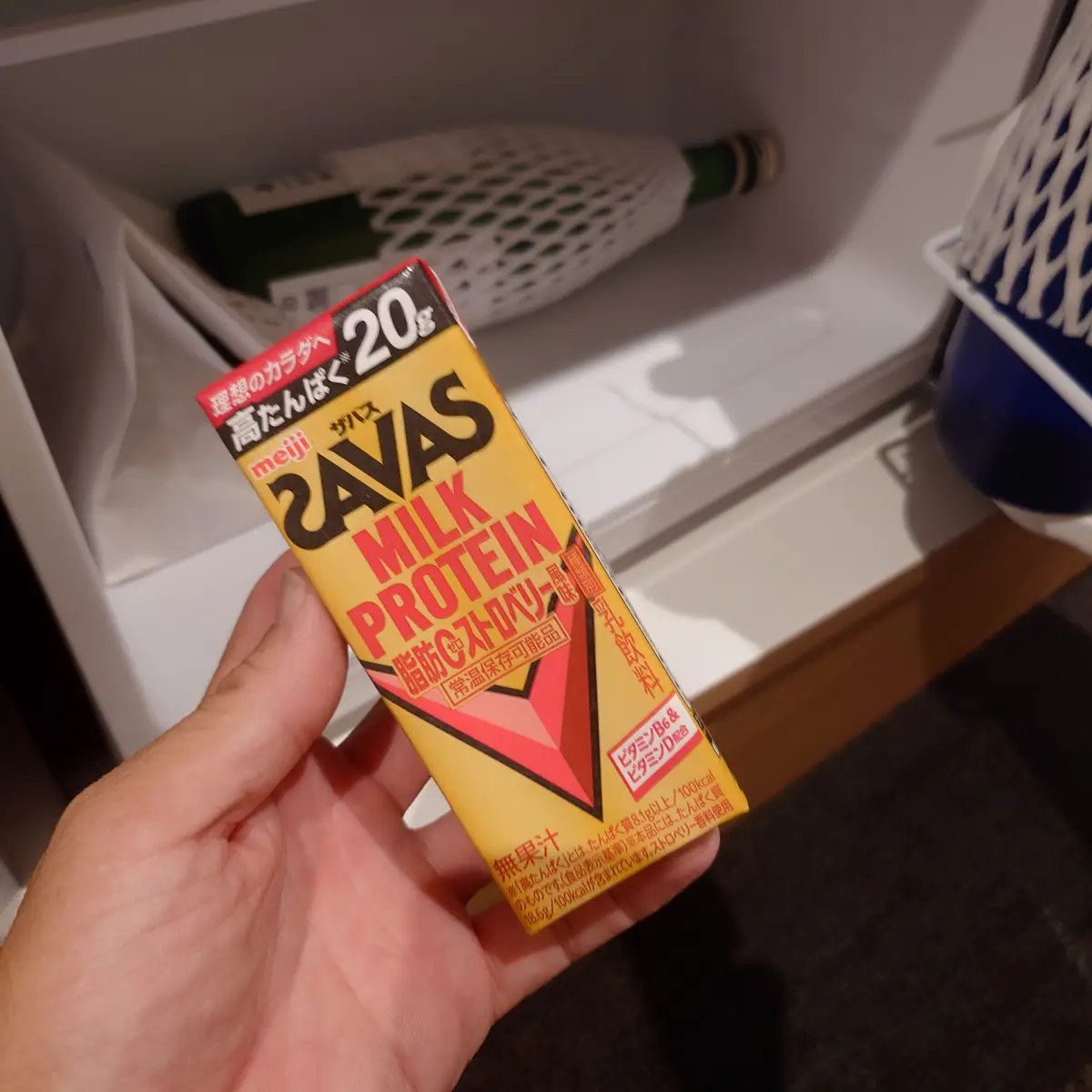 冷蔵庫から取り出したザバスミルクプロテインを手に持つ瞬間