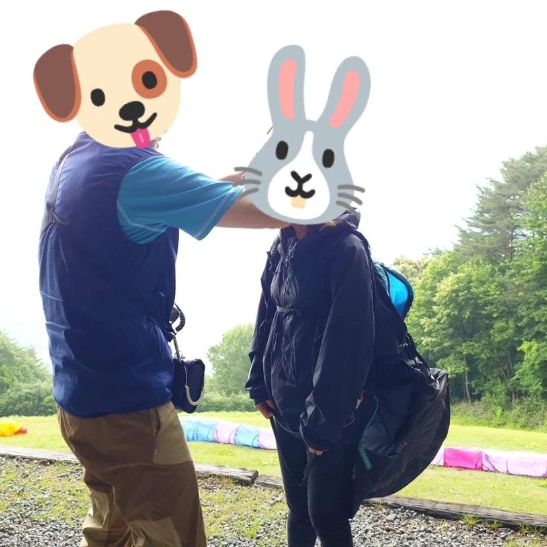 パラグライダーのタンデムフライトに向けて装備を整えるユン